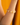 The Moonlet Bracelet in Golden Honey worn on a model’s wrist, set against a warm golden backdrop. Irregular freshwater pearls and smooth yellow fluorite beads are strung side by side, with delicate 14k gold beads in between.