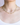 Close-up image of the Astrid Necklace in peridot worn on the neck, showcasing vivid green faceted peridot gemstones paired with white freshwater pearls and tiny 14k gold spacer beads. The necklace lies gracefully along the collarbone.