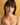 Close-up portrait of a model wearing the Aura Citrine Necklace layered with a strand of rondelle pearls interspersed with tiny gold and yellow beads. The Aura necklace features sparkling faceted citrine gemstones in graduated shades of golden-yellow, each delicately separated by small, round 14k gold spacer beads. The necklace gently rests along the collarbone, secured with a refined 14k gold clasp. Matching pearl earrings complement the necklaces against a warm, golden background.