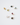 Collection of 14k gold capsule charms with assorted gemstone cabochons including citrine, peridot, topaz, garnet, moonstone, and black star sapphire.