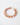 Round peach moonstone bracelet with a 14k gold toggle clasp and tiny faceted gold spacer beads, arranged in a circular shape on a white surface.
