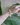Bracelet styled on the wrist, displaying luminous white freshwater pearls paired with sparkling spring-green faceted peridot stones. Tiny 14k gold spacer beads catch the light between each bead, creating a fresh, radiant effect against the skin.