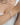A model wearing The Moonlet Bracelet in Dusk Violet on her wrist and the matching necklace at her neckline. The bracelet showcases freshwater pearls and rich purple fluorite beads strung in a balanced rhythm, accented with silver details and styled with a white ribbed tank.